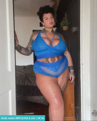 Person wearing a blue lingerie set in a room.