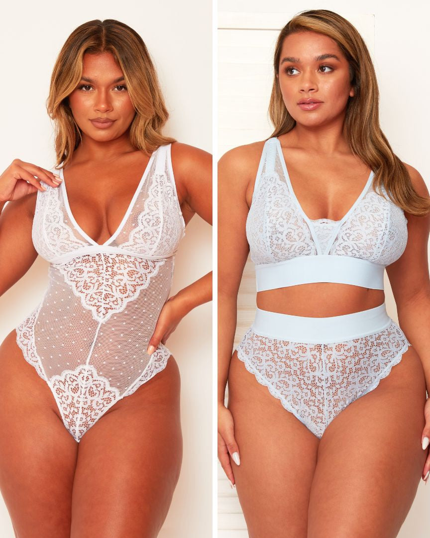 Two women modeling lace lingerie against a plain background