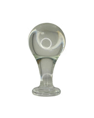Clear glass butt plug with a rounded top and cylindrical base on a white background