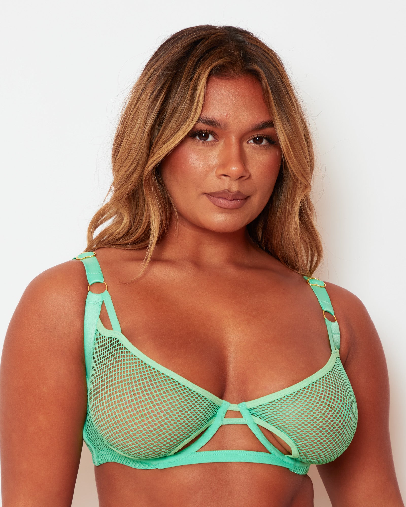 Close-up of the Tutti Rouge Aphrodite Apple Green fishnet bra, showing cut-out cups and gold-tone strap rings.