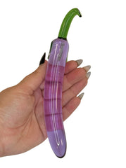Purple Glass Toy from Brand X By Tutti inspired by the shape and look of an aubergine in a hand for size context