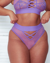 Close-up front view of the Abigail brief in Amethyst Orchid, featuring sheer polka-dot mesh, a wide waistband, and decorative criss-cross strap detailing at the front for a flattering, contemporary look.