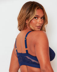 Close-up back view of the Brooke Fuller Bust Bralette in Oceanic Blue featuring sheer mesh back panels, floral lace, adjustable straps with gold heart sliders and supportive wide underband.