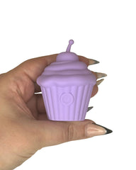 Lilac coloured cupcake shaped discrete sex toy in hand for size context