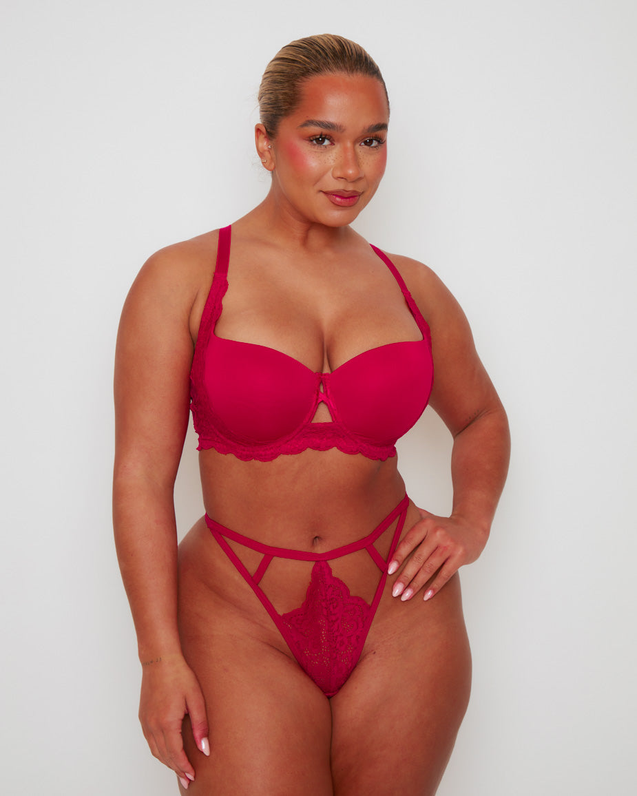 Front view of the Daley T-Shirt Bra and Portia Thong in Very Cherry, featuring smooth moulded cups, delicate floral lace accents, and a feminine centre-front keyhole detail. The matching strappy lace thong adds a bold and flattering finish.
