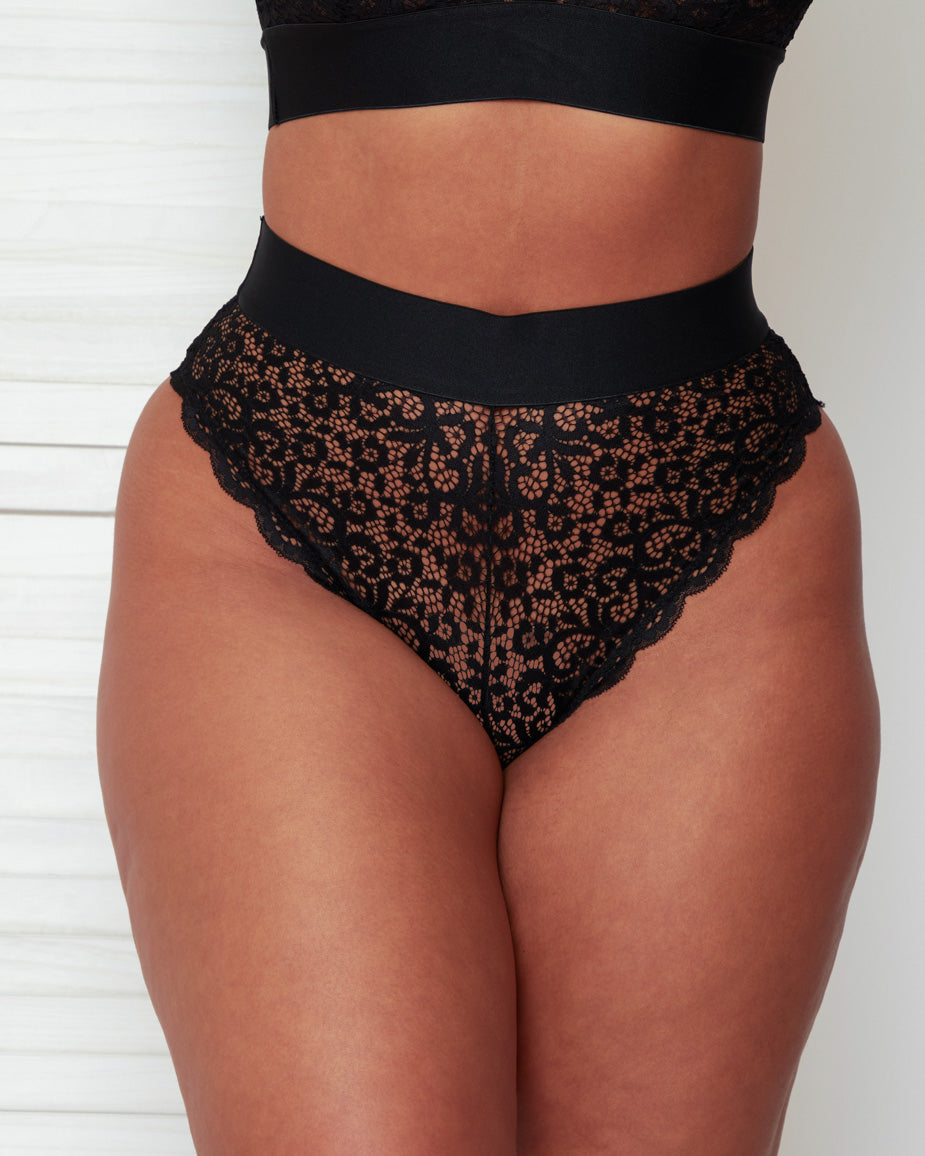 Close-up front view of the Hallie Brazilian Brief in Black by Tutti Rouge, featuring intricate floral lace, a wide elastic waistband, and a flattering high-leg cut.