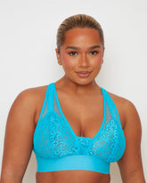Close-up of the Hallie Bralette in Bluebird Blue, featuring floral lace cups layered over soft mesh panels, a deep V-neckline, and a wide underband for comfort and support.