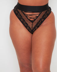 Front close-up of the Tutti Rouge Maya High Waist Brief in Midnight Black featuring sheer dotted mesh, floral lace panels, a wide waistband and striking lace-up front detail.