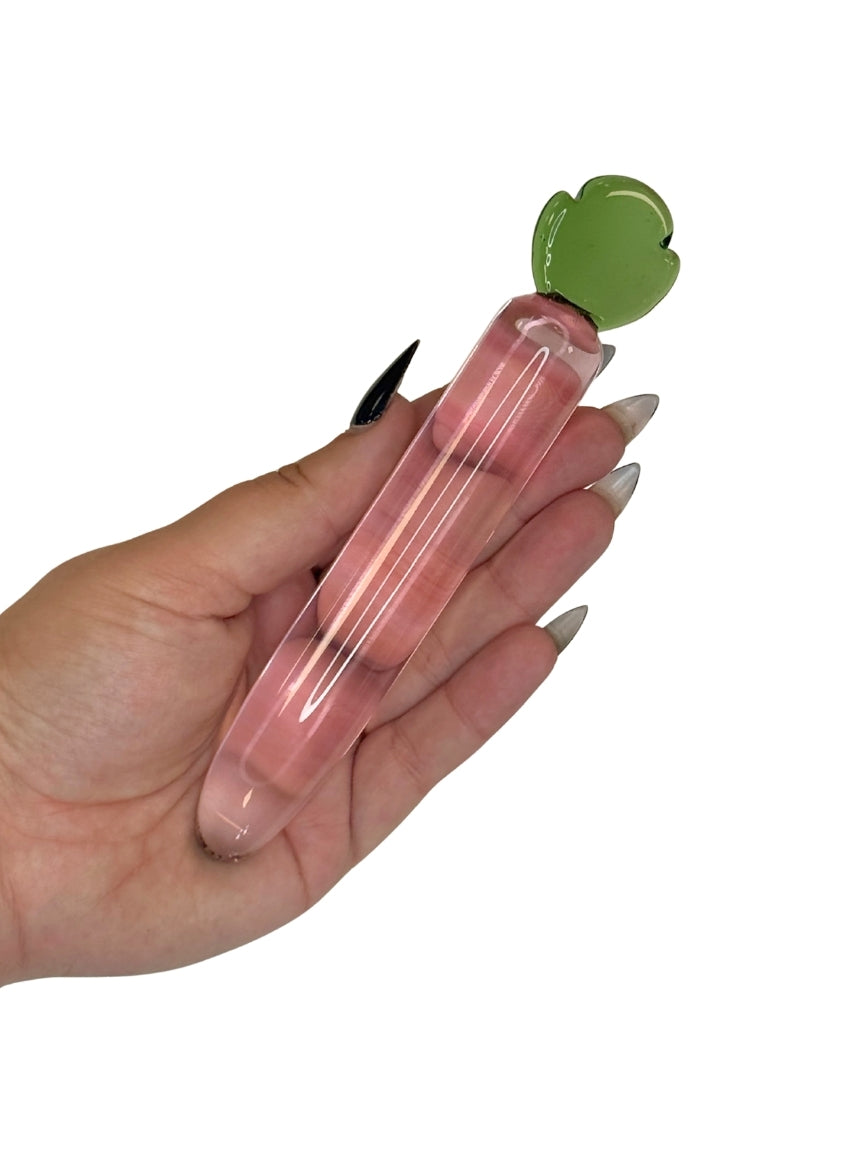 Glass Toy from Brand X by Tutti, in the same of a long raddish in a hand for size context