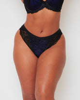 Front close-up of the Tutti Rouge Ramona High Waist Brazilian Brief in Midnight Black & Devil Blue, featuring rich blue floral lace, sheer black mesh panels and a smooth high-waisted silhouette.