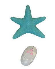 Turquoise starfish-shaped object with a remote control on a white background