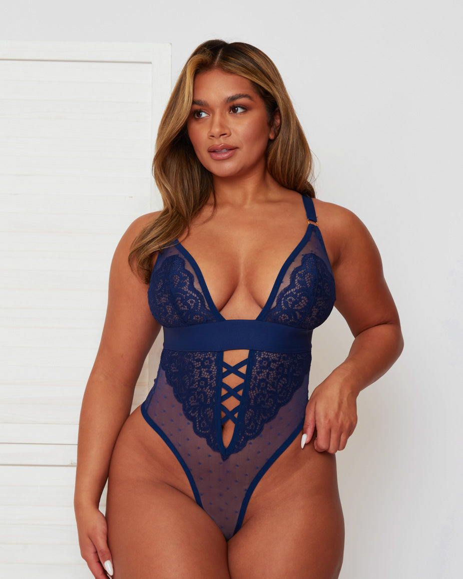 Front view of the Tutti Rouge Stormy Bodysuit in Oceanic Blue featuring floral lace cups, sheer dotted mesh, plunging neckline, criss-cross front detail and high-leg thong design.
