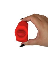 Hand holding a red silicone vibrator against a white background
