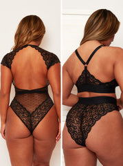 Black lace lingerie set worn by a model on a plain background