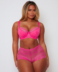 Front view of the Tutti Booster Fuller Bust Lingerie Set in Saucy Strawberry featuring a supportive underwired lace bra with matching floral lace shorts in a vibrant hot pink colour.