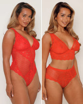 Woman wearing a red lace lingerie set on a plain background