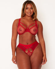 Woman wearing a red lingerie set on a white background