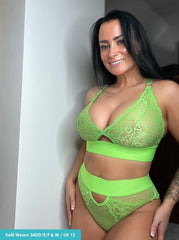 Woman wearing a green lace lingerie set against a neutral background