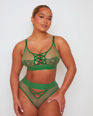 Front view of the Abigail lingerie set in Amazon Green, showcasing a sheer mesh bralette with lace-trimmed cups and criss-cross strap detailing, paired with a high-waisted brief featuring sheer polka-dot mesh panels and decorative strappy accents.