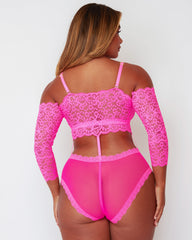 Back view of the Alix Bodysuit in Pink, featuring an off-the-shoulder lace back, sheer mesh rear panel, decorative lace trim, and elegant strap detailing connecting the top and brief sections.