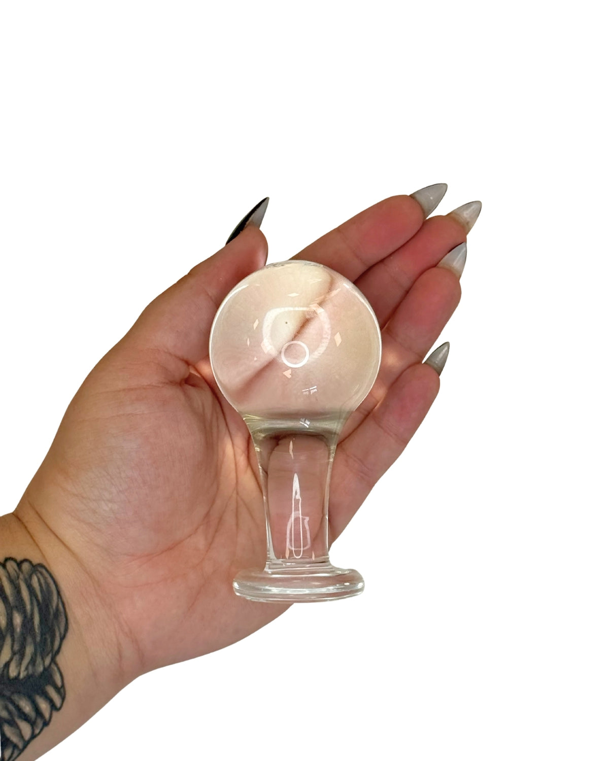 Brand X by Tutti toys clear glass sex toys - showing the size of the Anal Orb Intermediate butt plug in hand.