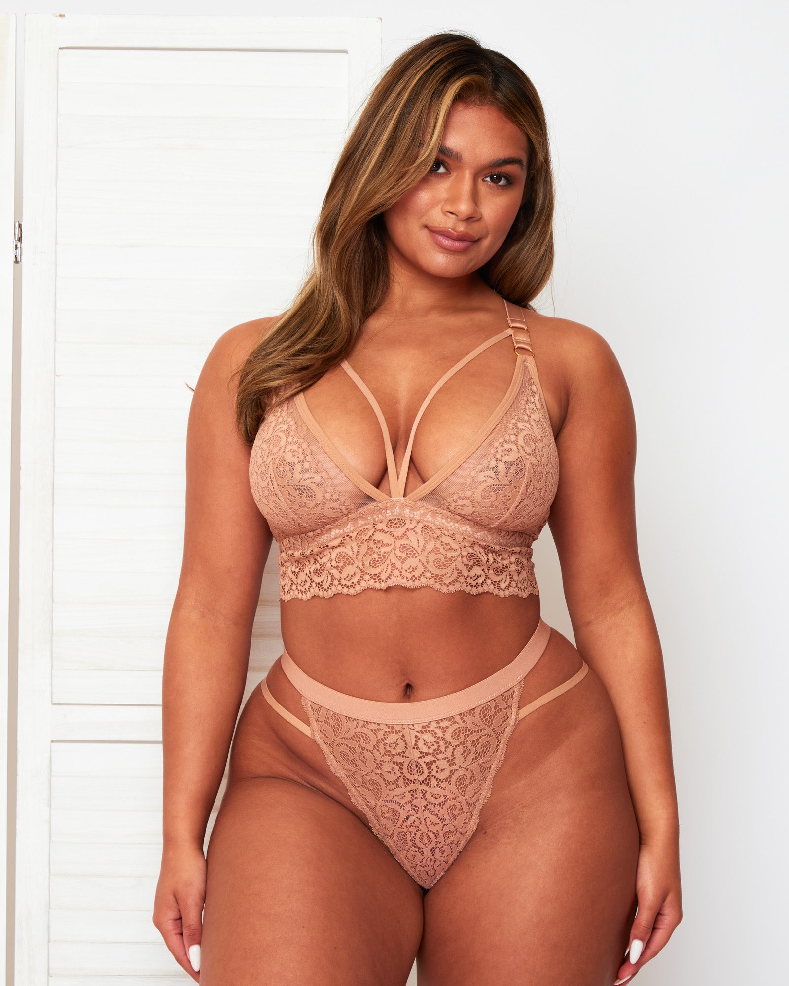 Front view of the Tutti Rouge Aria Warm Sand lace lingerie set with a plunging bralette and matching double strap thong.