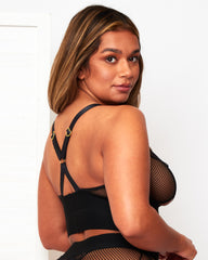 Angled rear view of the Tutti Rouge Athena black bralette, featuring fishnet side panels and straps joined by a gold-tone ring.
