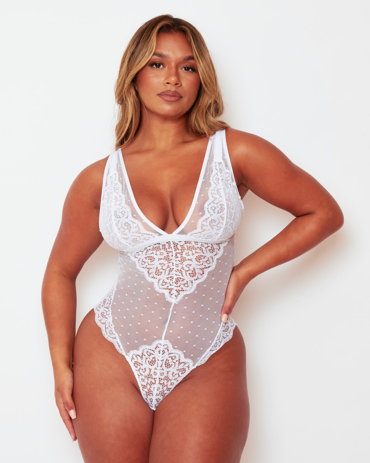 Front view of the Tutti Rouge Eva White bodysuit with a deep plunge neckline, floral lace panels and sheer dotted mesh.