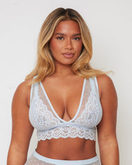 Front view of the Eva Bralette in Ballad Blue by Tutti Rouge, featuring delicate floral lace, sheer dotted mesh panels, and a flattering plunge neckline for a soft, feminine look.