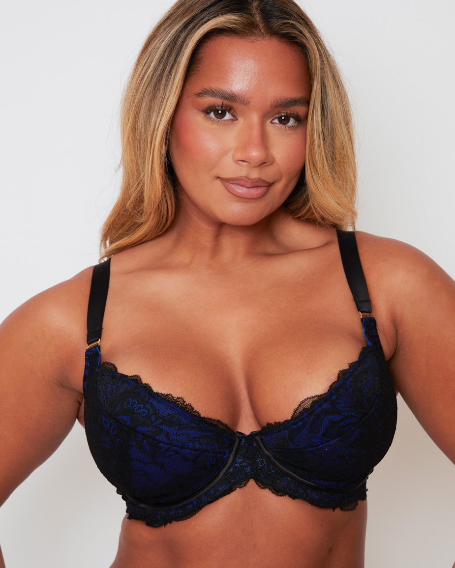 Front close-up of the Tutti Rouge Ramona Padded Plunge Lace Bra in Midnight Black & Devil Blue, featuring supportive padded plunge cups, rich blue floral lace, delicate scalloped edging and a flattering low neckline.
