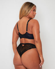 Back view of the Tutti Rouge Ramona Padded Plunge Lace Bra in Midnight Black & Devil Blue, showcasing adjustable straps with signature gold-tone heart hardware, a secure hook-and-eye fastening and elegant lace wings.