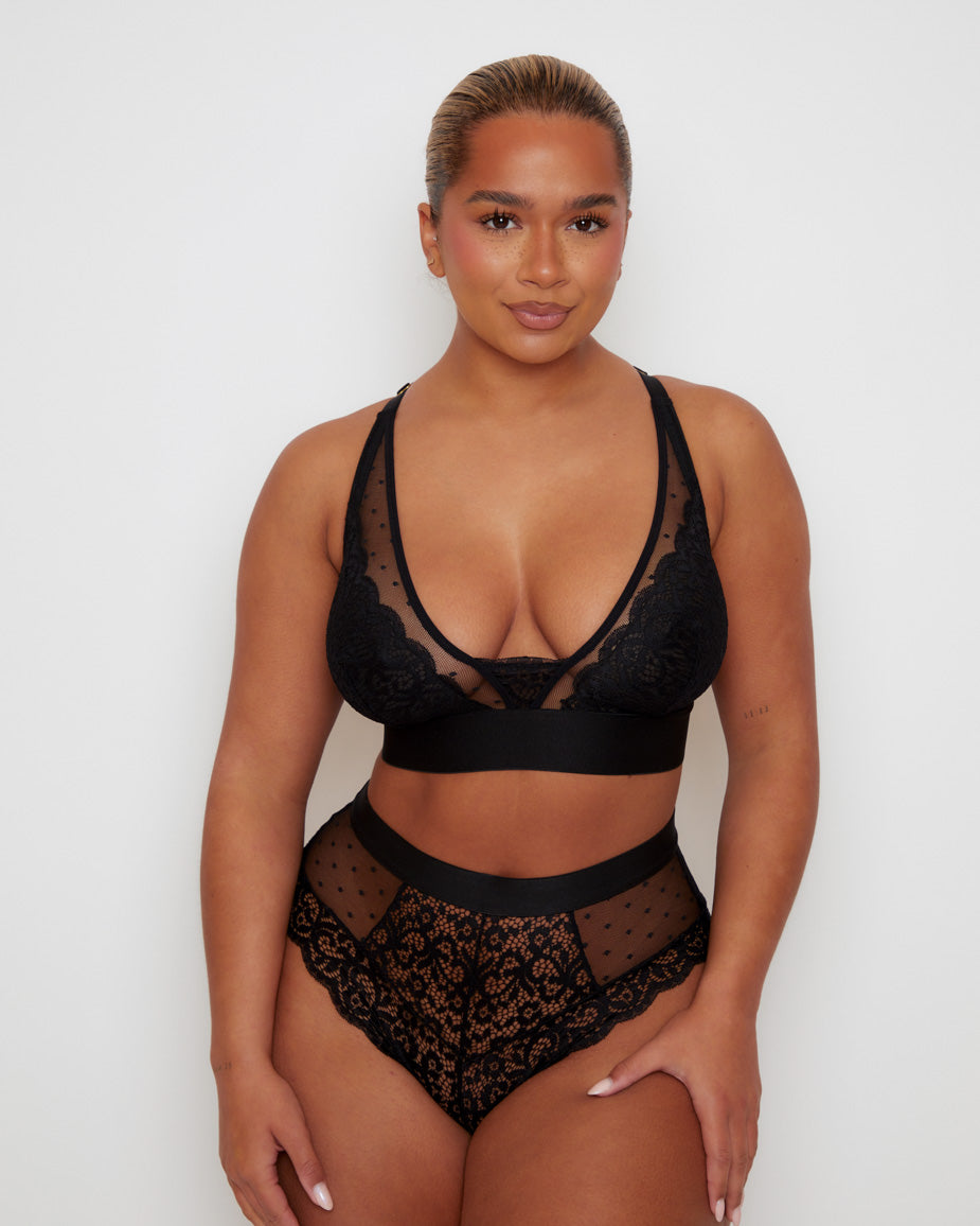 Front view of the Tutti Rouge Riley Bralette in Midnight Black paired with the matching Riley Brief, featuring delicate floral lace, sheer dotted mesh and a deep plunge neckline.