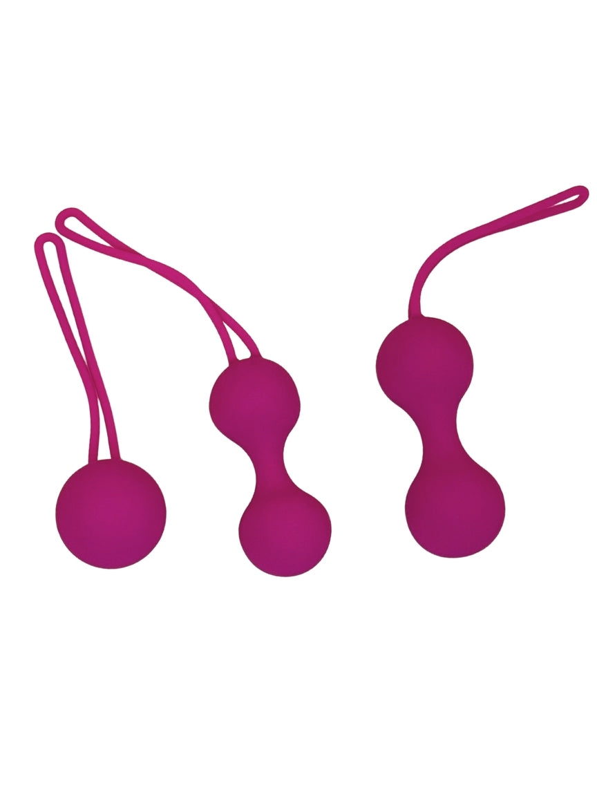 Two pink silicone balls with strings on a white background