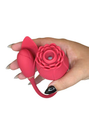 Hand holding a pink silicone flower-shaped vibrator toy on a white background