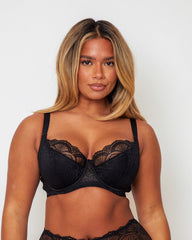 Front close-up of the Tutti Rouge Tutti Booster Lace Fuller Bust Bra in Luscious Liquorice showcasing supportive underwired cups with intricate black floral lace.