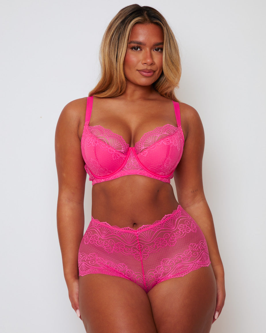 Front view of the Tutti Booster Fuller Bust Lingerie Set in Saucy Strawberry featuring a supportive underwired lace bra with matching floral lace shorts in a vibrant hot pink colour.